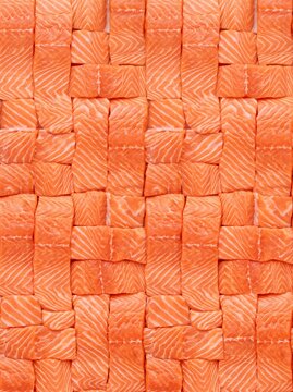 Fresh raw salmon fillets arranged in a basketweave pattern provide a detailed food texture in a portrait orientation for seafood marketing, culinary backgrounds, and restaurant menu designs.