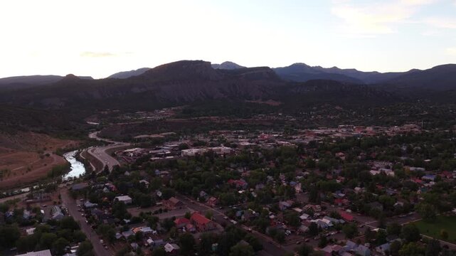 Sunset aerial of US 160 highway commercial corridor and neighborhoods in Durango Colorado with Animas river