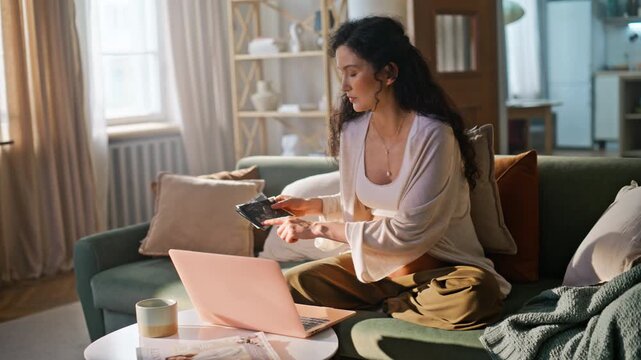 Mom-to-be showing sonogram laptop call. Pregnant lady relaxing cozy sofa home.