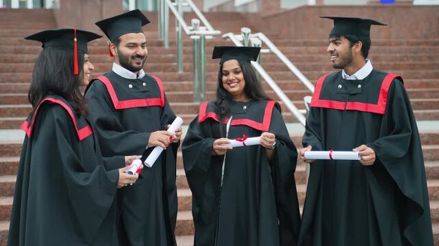 Happy graduates celebrating academic success with diplomas