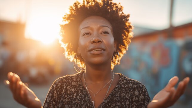 Black woman preaches on street with raised hands at sunset. Urban outdoor scene. Faith and spirituality concept.