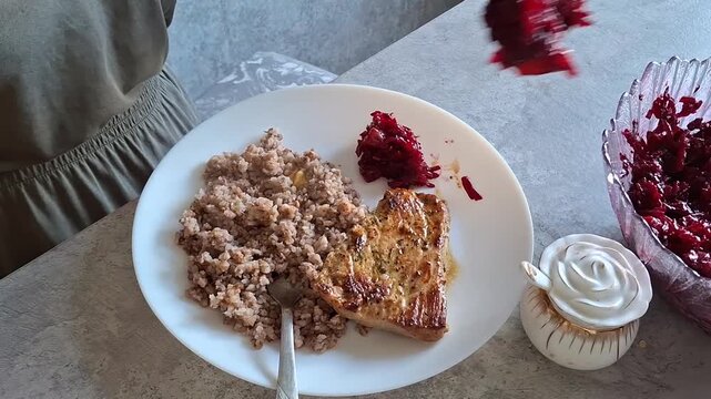 Eating dinner with rice, meat, and salad at home in a kitchen setting