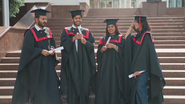 Happy indian students celebrating graduation day together