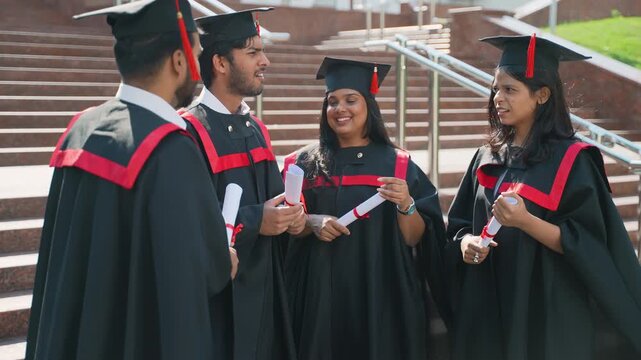 Group of indian graduates celebrating with diplomas