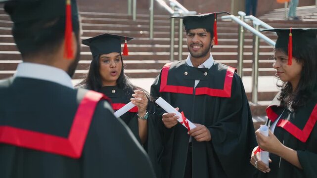 Indian graduates celebrating and talking together at university campus
