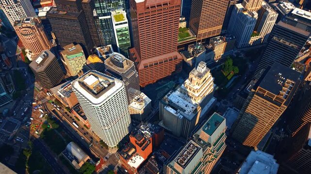 Rising over the tops of diverse high-rises in the Financial District of Boston, Massachusetts, USA. Streets of lively city from top view.