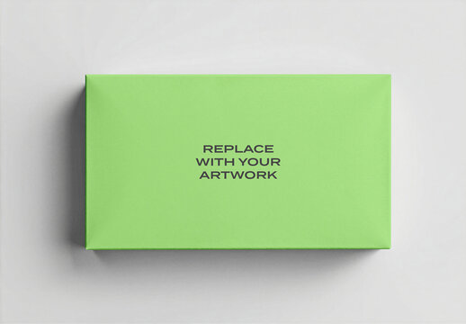 Rectangular box mockup with placeholder text on a light gray surface, realistic product packaging presentation, blank template for branding or design, clean studio environment flat top view