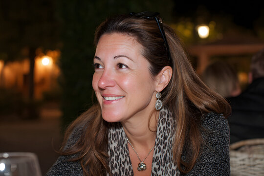 Smiling woman in an outdoor night setting