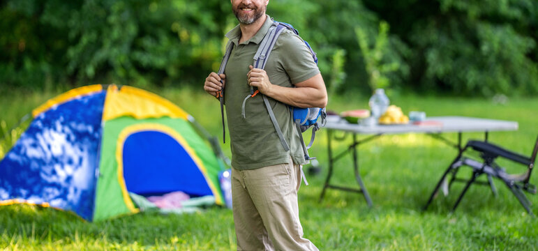 Picnic time. Man at camp picnic in forest. Man hiking on summer day. Summer camp activity. Summer camping retreat. Camp adventure. Hiking lifestyle. Man at campsite, cropped view