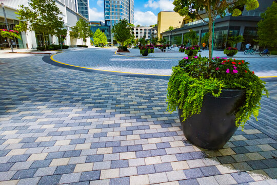 Colorful landscaping accents patterned paving and contemporary mixed use architecture in Virginia.