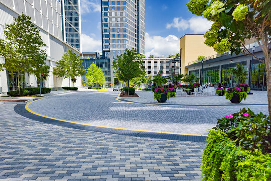 Spacious Reston plaza features patterned paving, outdoor furniture, and modern architecture.