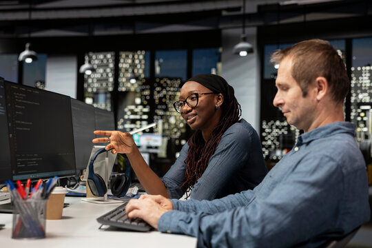 Cheerful startup intern asks a senior programmer questions about advanced AI algorithms and machine learning models while requesting help from a manager with automation work in the office.