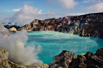 Turquoise Crater Lake Surrounded by Volcanic Cliffs at Mount Ijen, East Java, Indonesia © Lili