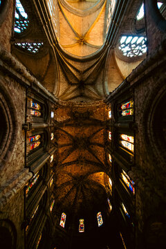 Low Angle View of Gothic Vaulted Ceiling and Stained Glass Windows in Avila Cathedral