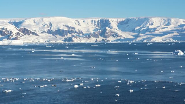 Antarctica Beautiful Landscape Ocean with Dozens of Icebergs and Bergy Bits, Wide Shot with Mountains Covered in Snow and Ice. View From Cruise Ship