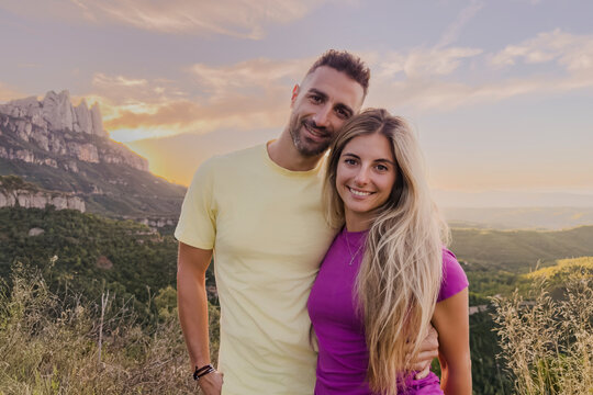 Young couple smiling enjoying mountain outdoor adventure