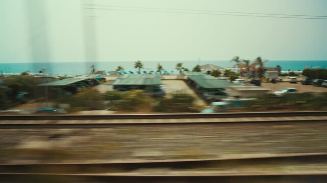 Seaside holiday homes in Calabria during the summer view from a train window