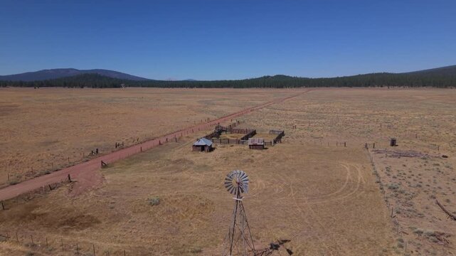Aerial flyover of working windmill and abandoned ranch compound, western Lassen County, California.