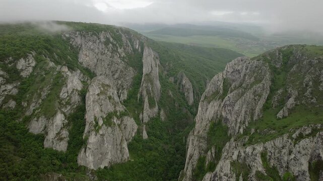 Majestic aerial view flying over the impressive limestone cliffs of Cheile Turzii, a natural reserve in the Apuseni Mountains of Romania