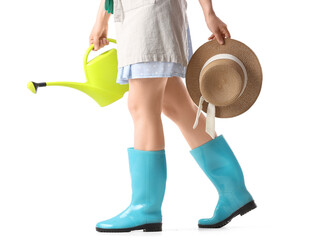 Gardening and outdoor hobby concept, woman in rubber boots holding watering can and straw hat on white background © Pixel-Shot