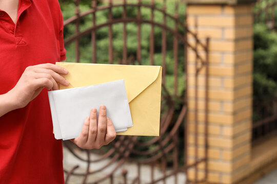 Mail delivery service, person in red uniform holding letters and envelopes for postal communication and correspondence