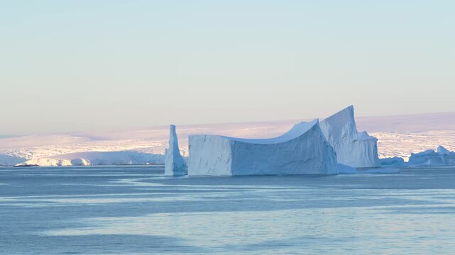 Huge Tabular Iceberg in Antarctica at Sunset. Beautiful Snow Covered Mountains Epic Nature Remote Destination. Incredible Panoramic Vista
