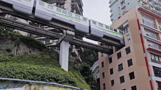 train enters liziba station inside a building on bridge in Chongqing china