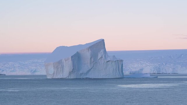 Antarctica Stunning Huge Tabular Iceberg at Sunset. Beautiful Snow Covered Mountains Epic Remote Nature Destination. Incredible Massive Ice Floating