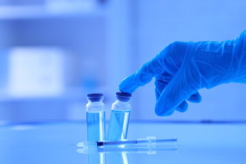 Fototapeta premium Vaccine development and medical research, gloved hand with vials and syringe for drug discovery and healthcare innovation