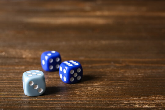 Different game dices on wooden background