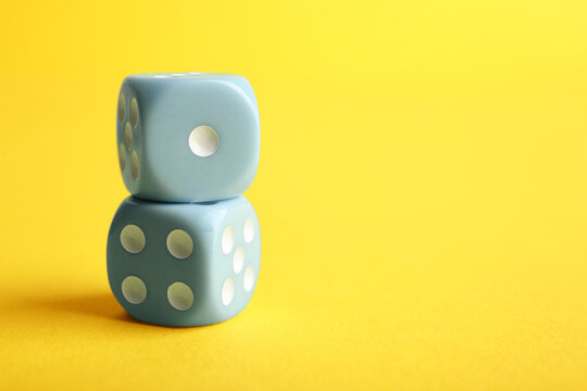 Blue game dices on yellow background