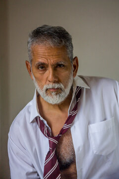 Charismatic Mature Man Leaning Forward in Studio Portrait