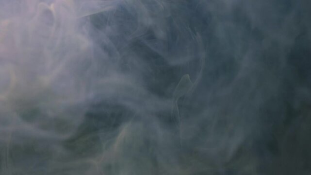 Shooting paint underwater with colors spreading in water in various shapes