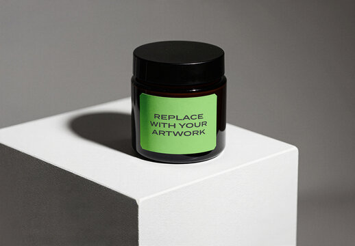 Glass jar mockup with black lid and label placeholder on white pedestal, minimalist product presentation, packaging design template, branding display, commercial shot, studio lighting