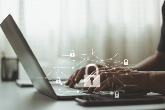 Cybersecurity concept showing laptop use with digital locks and connected network lines, representing data security, online privacy, information protection, secure access, and digital risk.