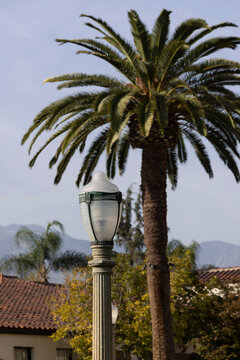 A historic concrete street lamp stands in historic downtown Azusa, California, USA.