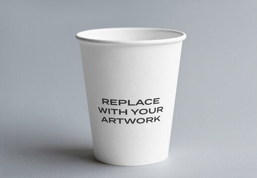 Paper cup mockup with placeholder text on a neutral gray surface, minimalist presentation for branding, packaging, and advertising, template graphic design print