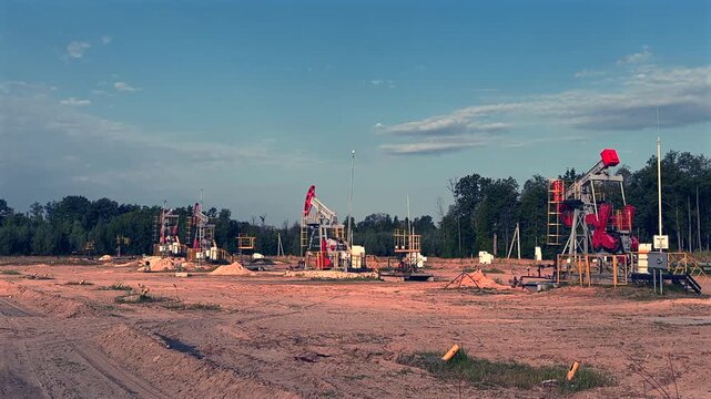 Oil extraction in oil field. Extraction of petroleum. Crude Oil Production. Crude pump jack working on oil field. Crude Pumpjack. Industrial petroleum industry.