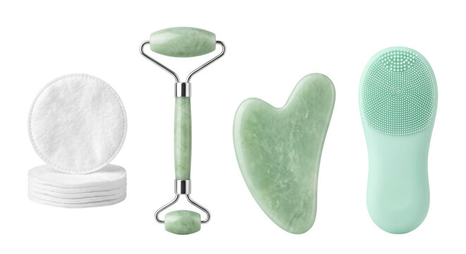 Set of facial skincare tools including jade roller gua sha and cleansing brush