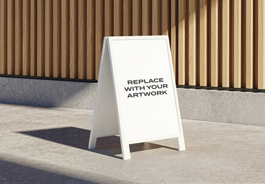 A-frame signboard mockup with placeholder text on concrete pavement, vertical display for outdoor advertising, wooden slat wall background, realistic graphic design presentation template
