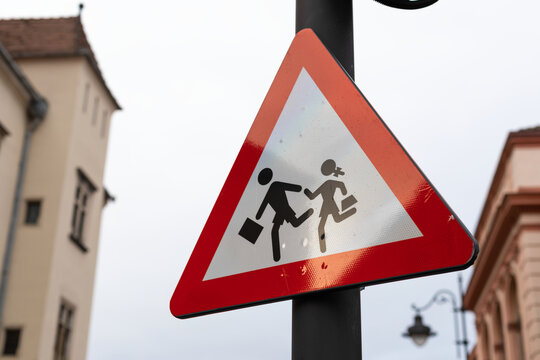 Humorous Warning Sign Showing Two People Running With Bags
