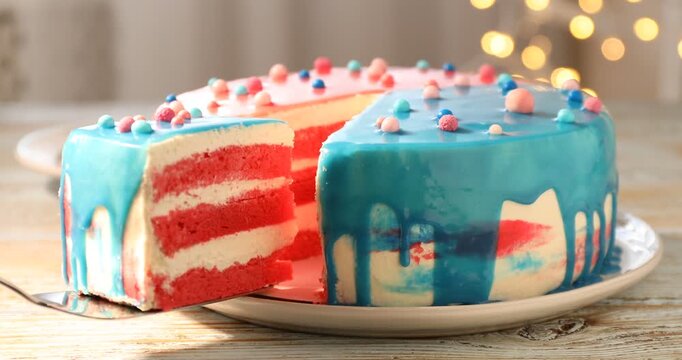 Baby gender reveal party. Woman taking slice of cake with pink layers at table, closeup