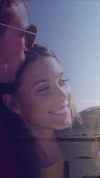 Animation of dots over happy caucasian couple on beach