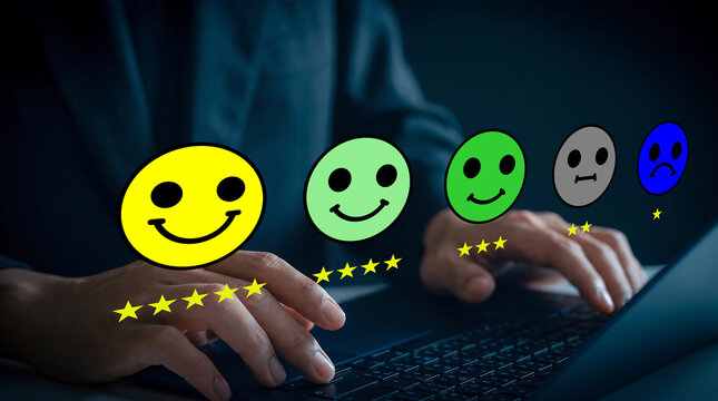 Customer review concept with a person typing on a laptop and giving a rating with smiley faces and stars