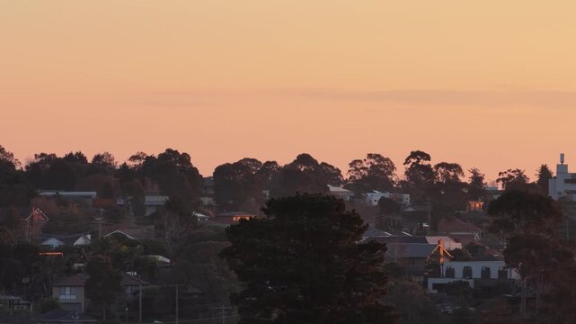 Aerial Sunset Reveal of Melbourne CBD Skyline From Suburban Treetops