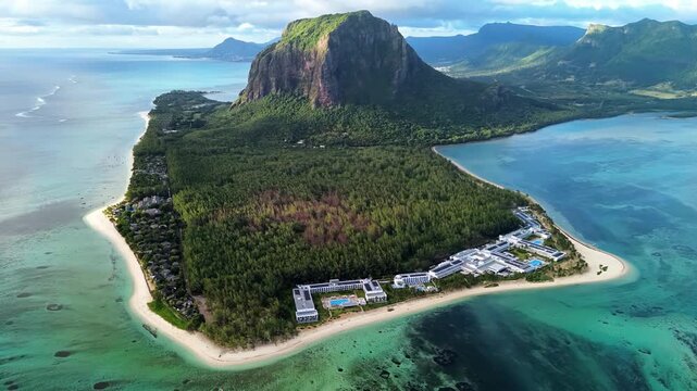 Stunning aerial motion of le morne brabant peninsula in mauritius revealing luxury resorts and turquoise ocean waters.
