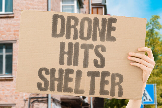 "drone hits shelter" An unmanned aerial vehicle crashes into a covered waiting area. DRONE. HITS. SHELTER. WAITING. AREA.