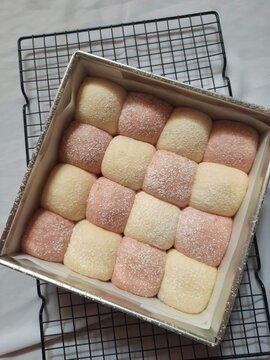 Freshly baked colorful soft pull apart bread buns in a square box packaging