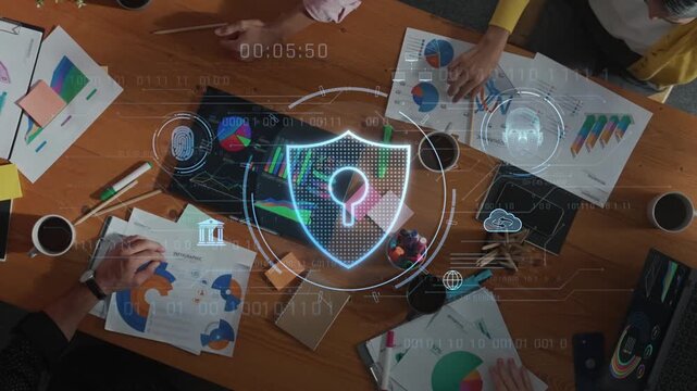 Overhead view of business team working on data security strategy. Digital lock symbol emphasizes importance of protection in modern office collaboration. Raster