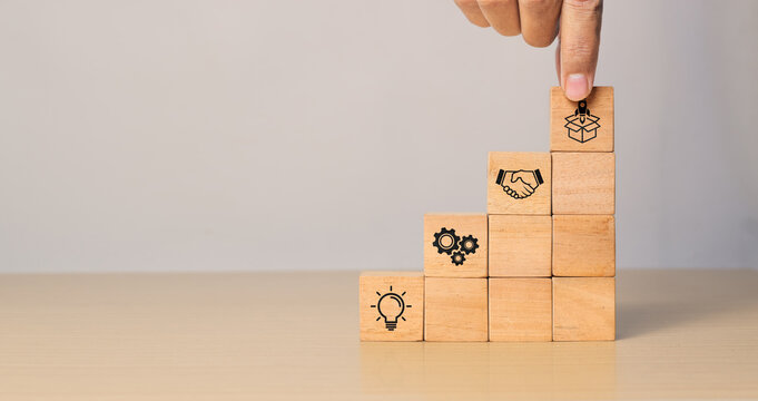 New product development and project roadmap concept. Wooden blocks with the stages of new product development icons, ideation, development and launching